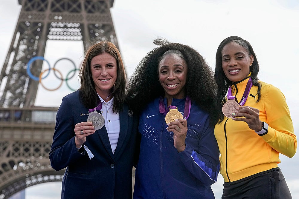 | Photo: AP/Michel Euler : 2012 London Olympics women's 400m hurdles: Zuzana Hejnova of the Czech Republic, left, Lashinda Demus of the United States, center, and Kaliese Spencer of Jamaica pose with their medals